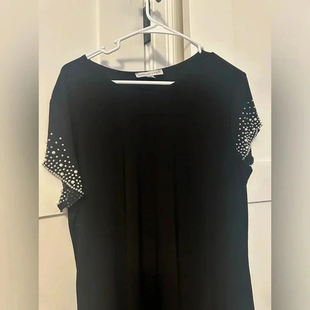 Little black dress with sleeve embellishments